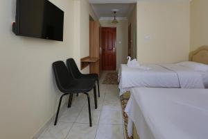 A bed or beds in a room at Gizem Pansiyon