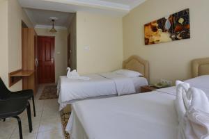 A bed or beds in a room at Gizem Pansiyon