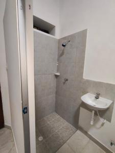 a bathroom with a shower and a sink at Hospedaje Monasterio in Buga