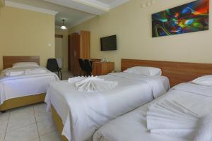 A bed or beds in a room at Gizem Pansiyon