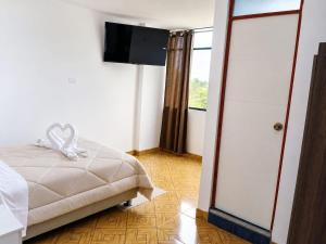 a bedroom with a bed and a sliding glass door at Villa Garden in Ica +4 photos