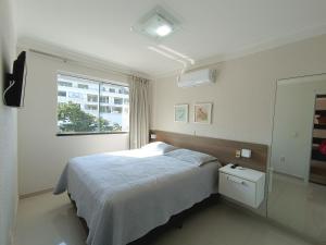 a bedroom with a bed and a window at Bombinhas Summer Beach in Bombinhas +47 photos