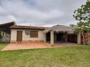 a small house with a grass roof at La Soñada in Coronel Martínez