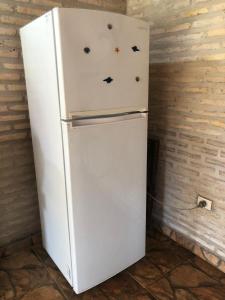 a white refrigerator in a room with stars on it at La Soñada in Coronel Martínez