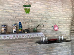 a brick wall with a shelf with figurines on it at La Soñada in Coronel Martínez