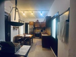 a kitchen with a table and a dining room at Second Home Ierissos in Ierissos +14 photos