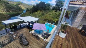 an outdoor deck with a view of a river at Hotel Deluxe Glamping in Guatapé