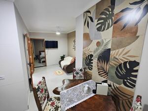 a living room with a couch and a table in a room at Cura e Conexões in Jarinu