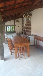 a large wooden table and chairs in a kitchen at Cura e Conexões in Jarinu