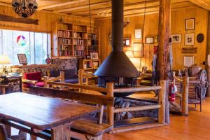 a living room with a table and a fireplace at Shadowcliff Mountain Lodge & Retreat Center in Grand Lake