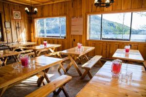 a dining room with wooden tables and windows at Shadowcliff Mountain Lodge & Retreat Center in Grand Lake