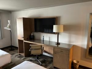 a hotel room with a desk with a lamp and a bed at Primm Valley Hotel & Casino in Jean