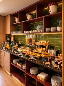 a display case in a kitchen with a bunch of food at INOTEL Paços de Ferreira in Paços de Ferreira