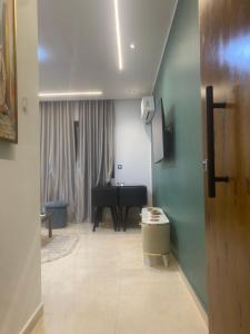 a living room with a piano and a table at Luxe appartement Khezama est in La Corniche +30 photos