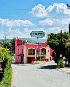 a hotel sign on the side of a street at Hotel Quinta Bella in Tula de Allende