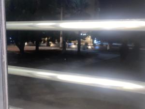 a window view of a city street at night at Luxe appartement Khezama est in La Corniche