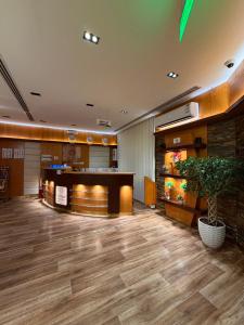 a lobby with a table and a potted plant at شقق السعادة سويت للشقق المخدومة - Saada Suites Serviced Apartments in Riyadh