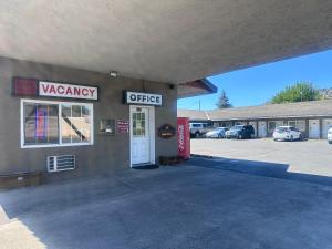 a view of a wagonasy office with a parking lot at Golden Eagle Motel in Dorris