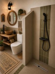 a bathroom with a shower and a toilet and a sink at Ocean Wings House in Rbat