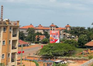 a building with a billboard in the middle of a street at Meraki Palate in Entebbe