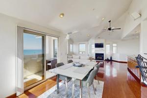 a living room with a white table and chairs at Park Avenue Beach Life in Cayucos +20 photos
