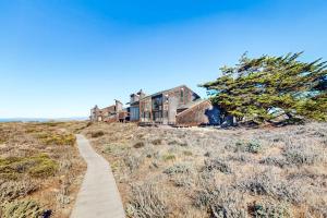 a house on top of a hill with a wooden path at Rita's-by-the-Sea in Moss Landing