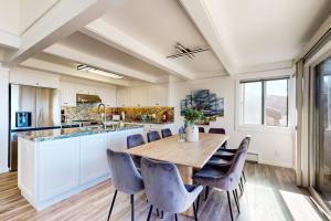 a kitchen with a large wooden table and chairs at Rita's-by-the-Sea in Moss Landing +33 photos