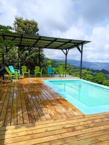 a swimming pool with chairs and a pergola at Finca La Puesta del Sol - Miramar de Sierpe in Sierpe +60 photos