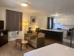 a living room and kitchen with a couch and a table at H&H Motor Lodge in Idaho Springs
