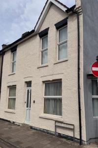 a white building with windows and a stop sign at Gillingham Hidden Gem in Gillingham
