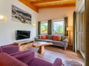 a living room with a couch and a table at Adlerblick in Werfenweng
