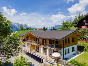 an aerial view of a house with mountains in the background at Adlerblick in Werfenweng