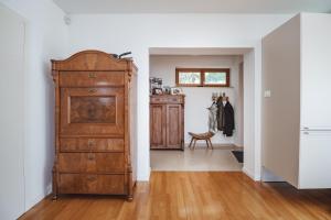 a room with a wooden chest of drawers and a hallway at Piran Panorama Pool Villa in Piran +32 photos