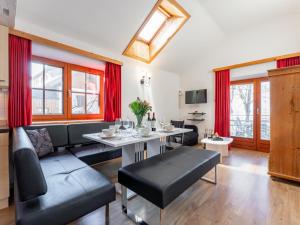 a living room with a couch and a table at Zederhaus in Mariapfarr