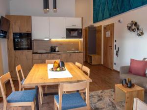 a kitchen and dining room with a wooden table and chairs at Bockblick Top 4 in Weisspriach