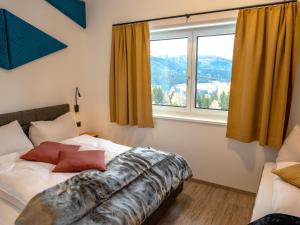 a bedroom with a bed and a large window at Bockblick Top 4 in Weisspriach