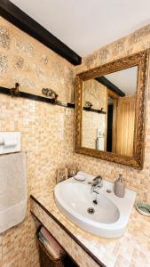 a bathroom with a sink and a mirror at La casita "A de Naval" in Pontevedra +46 photos