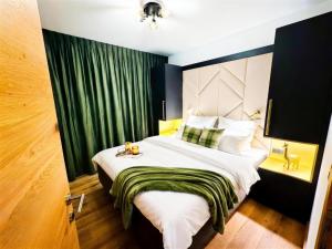 a bedroom with a large bed with a green curtain at Grebenzen 66 in Sankt Lambrecht
