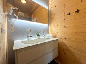 a bathroom with a sink and a wooden wall at Rattendorf 23B in Rattendorf +39 photos