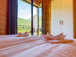 a bedroom with a bed with a large window at Rattendorf 23B in Rattendorf
