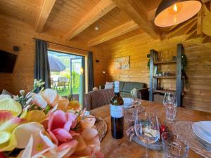 a wooden room with a table with a bottle of wine at Rattendorf 23B in Rattendorf