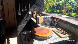 a stone counter with a wooden bowl and utensils at Pousada Rainha das Águas in Ilhéus