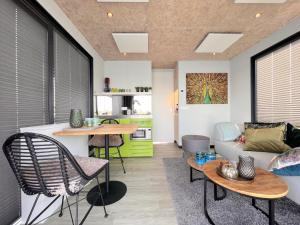 a living room with a couch and a table at Jopies Houseboat in Maasbommel