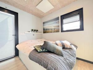 a bedroom with a bed with two pillows on it at Jopies Houseboat in Maasbommel