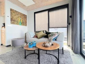 a living room with a couch and a table at Jopies Houseboat in Maasbommel +14 photos