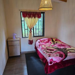 a bedroom with a bed and a window at Finca La Preciosura in El Peñol