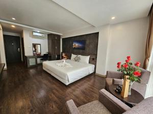 a hotel room with a bed and a living room at Moon Hotel 66 Bui Thi Xuan in Hanoi +16 photos