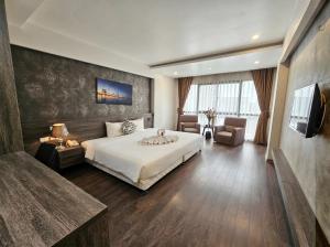 a hotel room with a bed and a television at Moon Hotel 66 Bui Thi Xuan in Hanoi