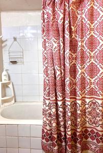 a shower curtain in a bathroom with a tub at Cabañas Deisy in Valdivia