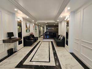 a lobby with couches and a television in a building at Moon Hotel 66 Bui Thi Xuan in Hanoi